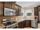 Modern kitchen with stainless steel appliances, tile backsplash, and granite counters at 4275 Hunters Walk Way, Cumming, GA 30028