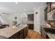 Granite countertop kitchen island features stainless steel appliances and dark cabinets at 4275 Hunters Walk Way, Cumming, GA 30028