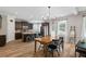 Open kitchen features dark cabinets, stainless appliances, granite counters, a kitchen island with bar stool seating, and dining area at 4275 Hunters Walk Way, Cumming, GA 30028