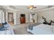 Spacious main bedroom with tray ceiling, large windows, carpet, and plenty of natural light at 4275 Hunters Walk Way, Cumming, GA 30028