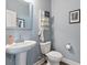 Stylish half-bathroom featuring a pedestal sink, modern fixtures, and neutral-toned walls at 4275 Hunters Walk Way, Cumming, GA 30028