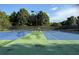 Outdoor tennis court surrounded by trees, available to all residents in the community at 4275 Hunters Walk Way, Cumming, GA 30028