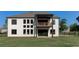 Rear exterior of home featuring a balcony, covered patio, and many windows at 2900 Waterford Dr Sw, Conyers, GA 30094