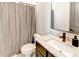Well-lit bathroom with a granite countertop, modern sink, and a stylish shower curtain, offering a functional and appealing space at 2900 Waterford Dr Sw, Conyers, GA 30094