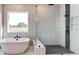 Spa-like bathroom with modern fixtures, a soaking tub, and a glass-enclosed shower at 2900 Waterford Dr Sw, Conyers, GA 30094
