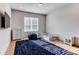Minimalist bedroom with natural light, ample storage, and a plush blue rug, creating a serene and comfortable retreat at 2900 Waterford Dr Sw, Conyers, GA 30094