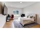 Bright bedroom with a plush bed, large TV, and dual desks, perfect for work or gaming at 2900 Waterford Dr Sw, Conyers, GA 30094