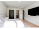 Bright bedroom features a plush bed, ensuite bathroom, and modern dark doors at 2900 Waterford Dr Sw, Conyers, GA 30094