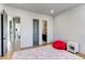 Spacious bedroom featuring hardwood floors, a fluffy rug, and a view of the nearby bathroom, creating a serene and welcoming space at 2900 Waterford Dr Sw, Conyers, GA 30094