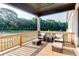 Relaxing covered deck with cushioned seating overlooking the private backyard at 2900 Waterford Dr Sw, Conyers, GA 30094