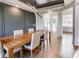 Dining room with grey accent wall, hardwood floors, and statement lighting at 2900 Waterford Dr Sw, Conyers, GA 30094