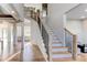 Spacious foyer with staircase featuring wood treads and black iron railing at 2900 Waterford Dr Sw, Conyers, GA 30094