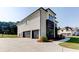 View of the side of the house featuring a three car garage and pristine landscaping at 2900 Waterford Dr Sw, Conyers, GA 30094
