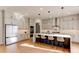 Spacious kitchen features white cabinetry, stainless steel appliances, and a large island with pendant lighting at 2900 Waterford Dr Sw, Conyers, GA 30094