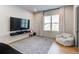 Cozy living room with a large window, plush seating, and a modern entertainment setup, perfect for relaxation and entertainment at 2900 Waterford Dr Sw, Conyers, GA 30094