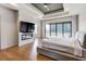 Main bedroom has a fireplace, TV, deck access, and modern lighting at 2900 Waterford Dr Sw, Conyers, GA 30094