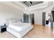 Spacious main bedroom with hardwood floors, tray ceiling, and ensuite bathroom access at 2900 Waterford Dr Sw, Conyers, GA 30094