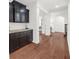 Hallway with hardwood floors, dark brown cabinets, and white trim at 4435 Manor Creek Dr, Cumming, GA 30040