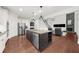 Open concept kitchen with large island, stainless appliances, and hardwood floors at 4435 Manor Creek Dr, Cumming, GA 30040