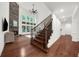 Comfortable living room with a stone fireplace and large windows provides natural light at 4435 Manor Creek Dr, Cumming, GA 30040