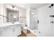 Elegant bathroom featuring white cabinetry, glass enclosed shower, and modern fixtures at 219 Phillips Ln, Alpharetta, GA 30009