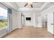 Spacious bedroom with tray ceilings, large windows, and a ceiling fan at 219 Phillips Ln, Alpharetta, GA 30009
