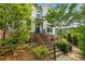 Charming two-story townhouse with brick accents, lush landscaping, and inviting stairway to the front door at 219 Phillips Ln, Alpharetta, GA 30009