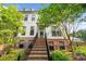 Two-story townhouse featuring a classic white facade, brick accents, and a welcoming staircase leading to the entrance at 219 Phillips Ln, Alpharetta, GA 30009