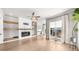 Bright living room with fireplace, built-ins, large windows, modern ceiling fan, and stylish hardwood flooring at 219 Phillips Ln, Alpharetta, GA 30009