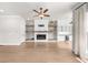 Bright living room featuring a fireplace with wooden shelves and a built-in bar at 219 Phillips Ln, Alpharetta, GA 30009