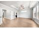 Spacious main bedroom featuring a tray ceiling, ceiling fan, wood-look floors, and ample natural light at 219 Phillips Ln, Alpharetta, GA 30009
