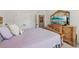 Bedroom with warm, inviting decor, featuring a classic dresser and a cozy bed, perfect for relaxation at 35 Henson Farm Dr, Loganville, GA 30052