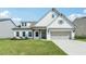 Charming two-story home featuring white brick, a well-manicured lawn, and a gray two-car garage at 35 Henson Farm Dr, Loganville, GA 30052