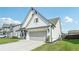 Well-maintained two-story home showcasing a gray two-car garage and a lush green lawn at 35 Henson Farm Dr, Loganville, GA 30052