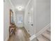 Entryway featuring hardwood floors, a decorative mirror, and staircase with carpeted steps at 35 Henson Farm Dr, Loganville, GA 30052