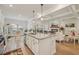 Bright, open kitchen with stainless steel appliances, granite countertops, and a large island with seating at 35 Henson Farm Dr, Loganville, GA 30052