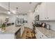 A well-lit kitchen featuring white cabinets, stainless steel appliances, granite counters, and tile backsplash at 35 Henson Farm Dr, Loganville, GA 30052