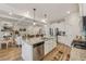 Kitchen featuring stainless steel appliances, granite countertops, a large island with seating, and coffered ceiling at 35 Henson Farm Dr, Loganville, GA 30052