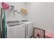 Laundry room featuring modern washer and dryer with shelving, providing ample storage space at 35 Henson Farm Dr, Loganville, GA 30052