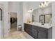 Main bathroom with double vanity, a walk-in closet, and a sleek glass-enclosed shower at 35 Henson Farm Dr, Loganville, GA 30052