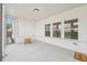Screened patio with white walls and brick baseboards, plus a small accent table, and 'welcome' mat at 35 Henson Farm Dr, Loganville, GA 30052
