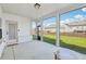 Bright screened-in patio with a view of the grassy backyard, brick baseboards, and white trim at 35 Henson Farm Dr, Loganville, GA 30052