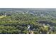 Aerial view of a beautiful home nestled in a lush, green neighborhood with mature trees at 5195 Overbend Trl, Suwanee, GA 30024