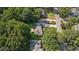 Aerial view of home with lush landscaping and mature trees at 5195 Overbend Trl, Suwanee, GA 30024
