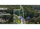 Aerial view showcasing the home's location on a spacious 0.7 acre lot with mature trees and lush greenery at 5195 Overbend Trl, Suwanee, GA 30024