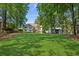 Expansive backyard with lush lawn and mature trees at 5195 Overbend Trl, Suwanee, GA 30024