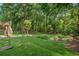 Spacious, lush backyard featuring mature trees, landscape, and a deck at 5195 Overbend Trl, Suwanee, GA 30024