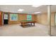 Spacious basement area features a classic billiard table, wood paneled walls, and ample room for recreation at 5195 Overbend Trl, Suwanee, GA 30024