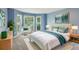 Serene bedroom with cool-toned walls, plush carpeting, and natural light streaming through multiple windows at 5195 Overbend Trl, Suwanee, GA 30024