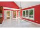 Bright breakfast nook with large windows, backyard views and red accent wall at 5195 Overbend Trl, Suwanee, GA 30024